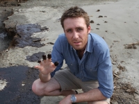 Philippe Cousteau shows oil on his fingertips during the BP Oil Spill.